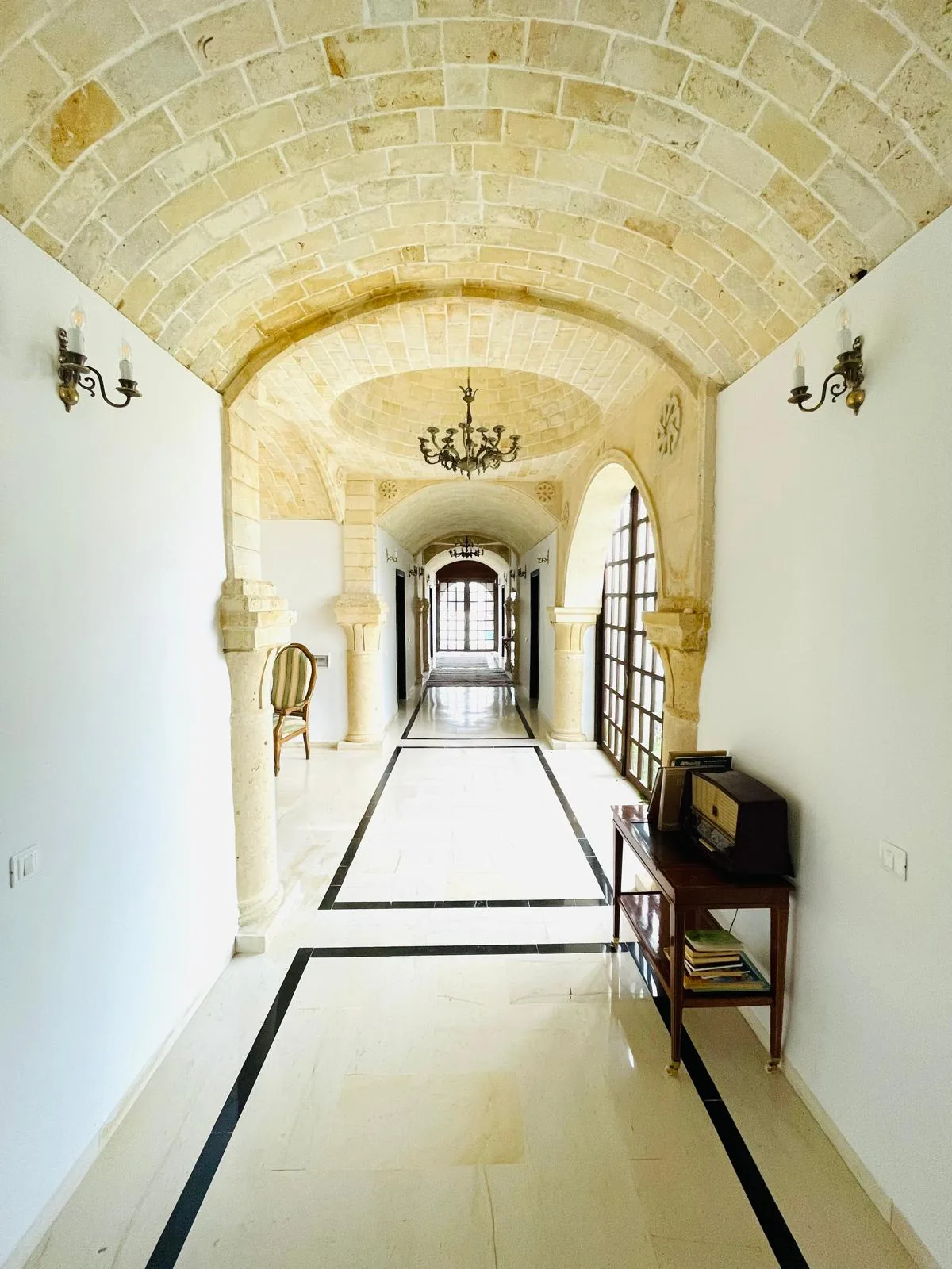 Vaulted stone corridor filled with daylight inside the Trinity Soul retreat property