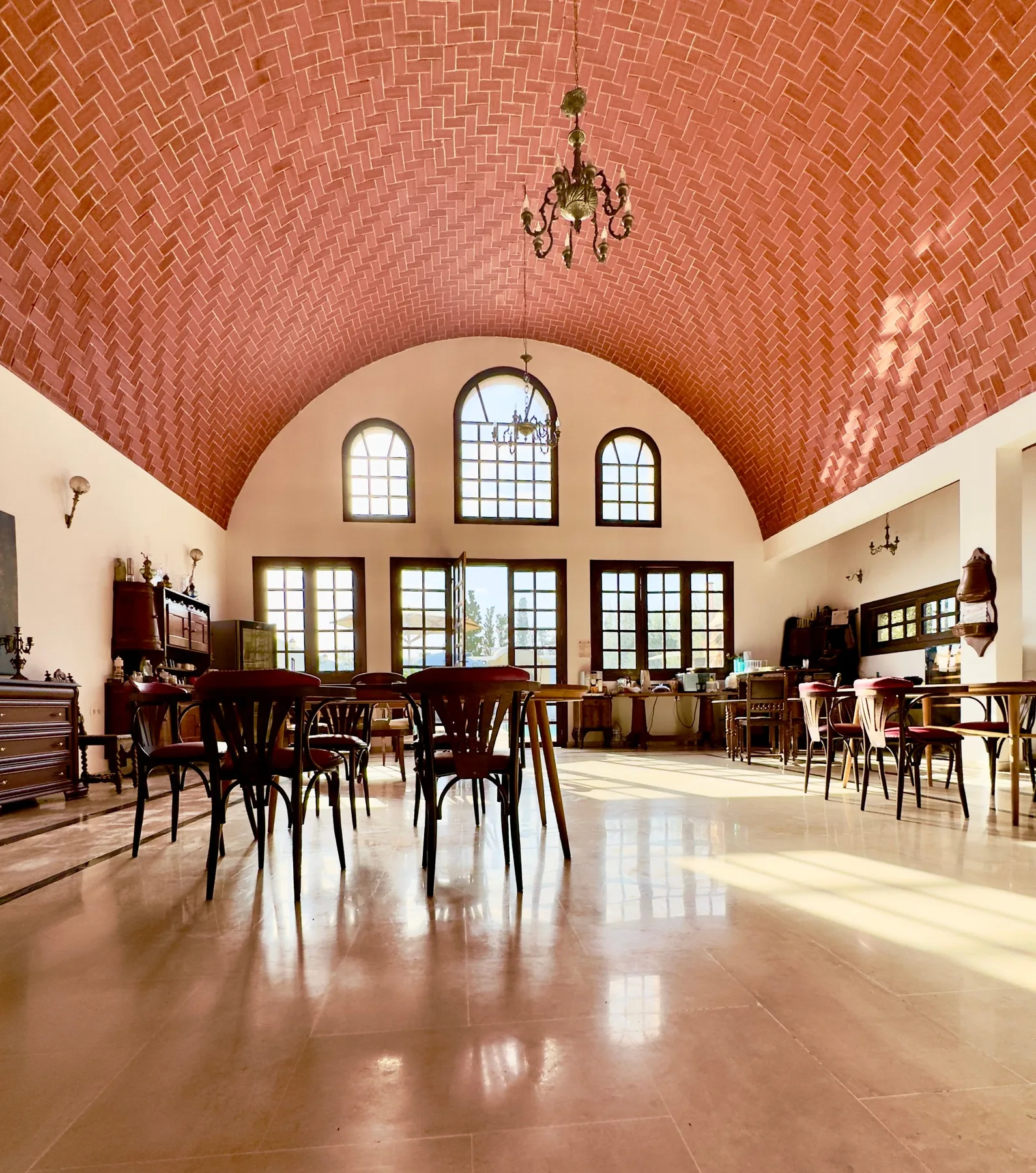 Common room with arched windows and a vaulted brick ceiling at the Trinity Soul retreat property