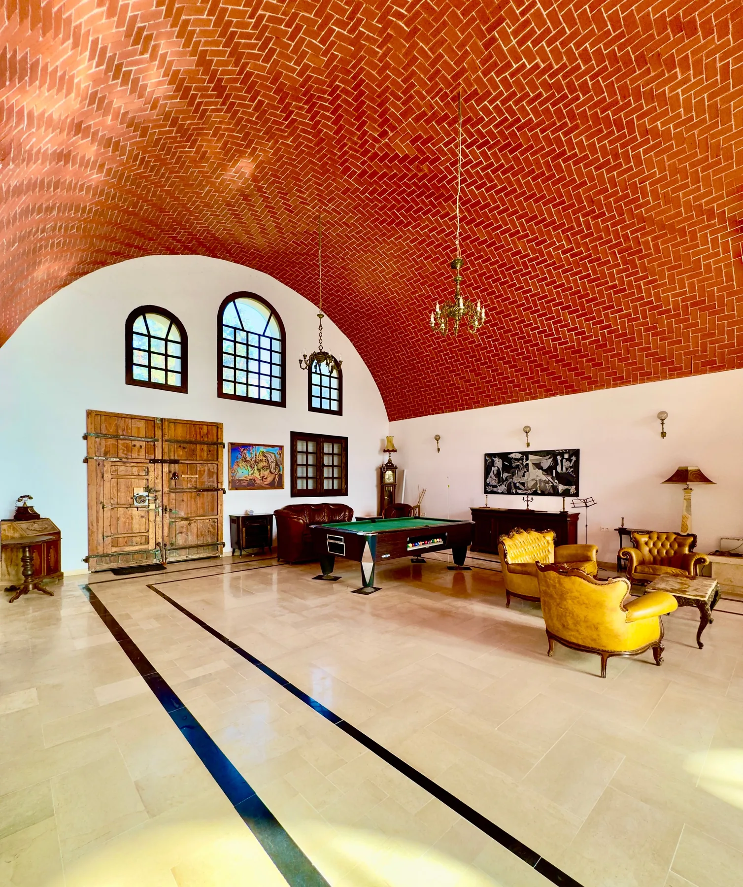 Warm common lounge with a vaulted brick ceiling at the Trinity Soul retreat property