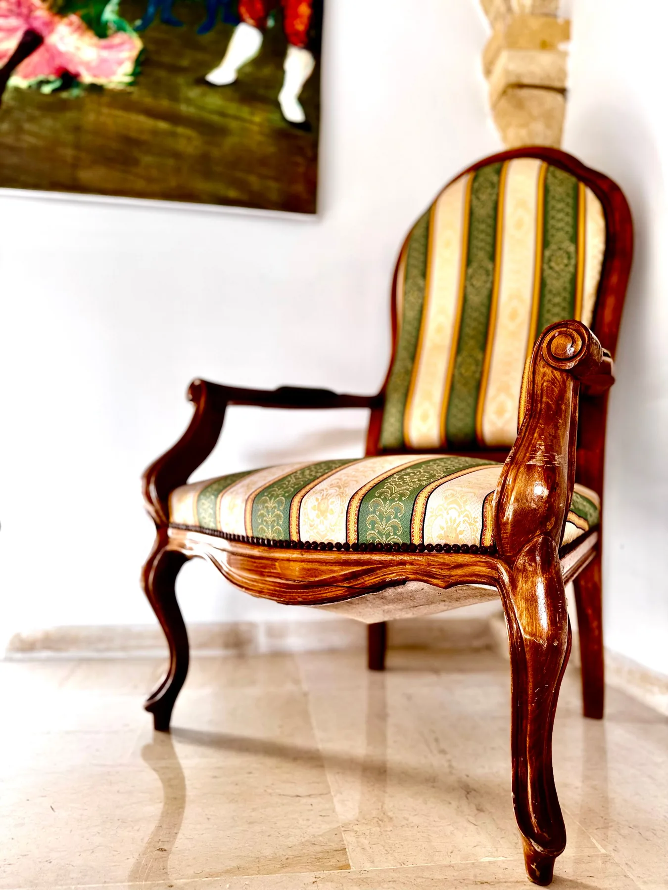 Antique upholstered armchair in a garden view room at the Trinity Soul retreat property