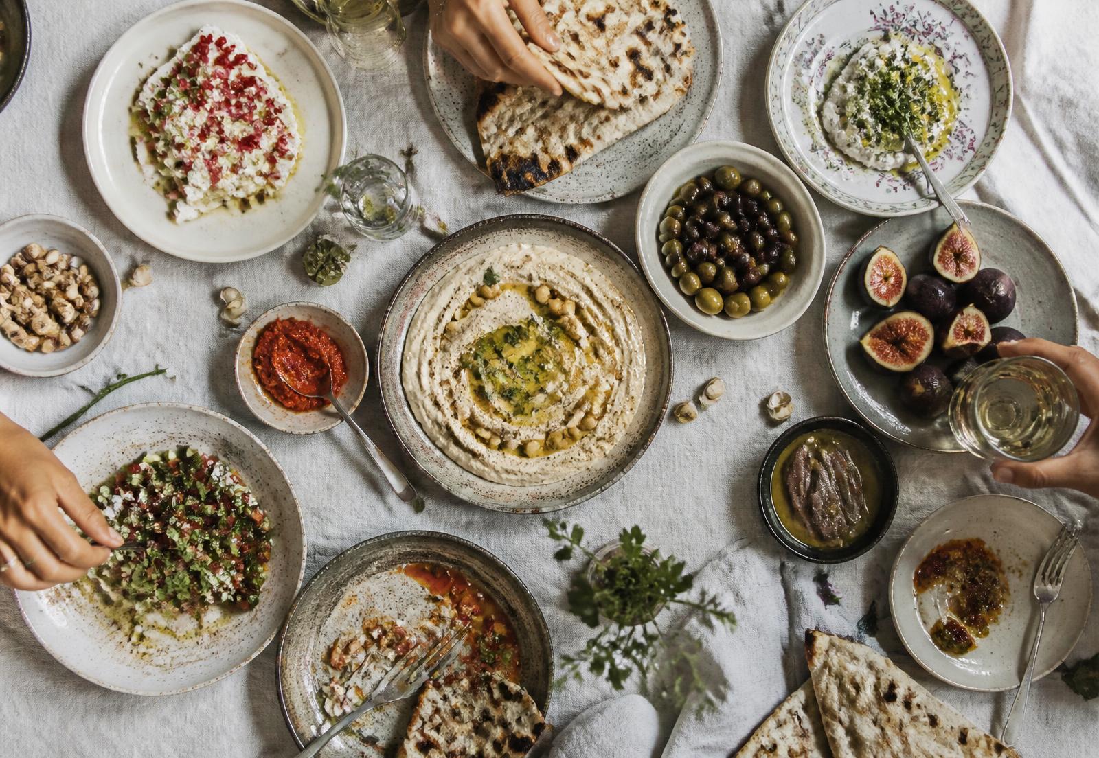 Overhead view of a shared Mediterranean mezze table